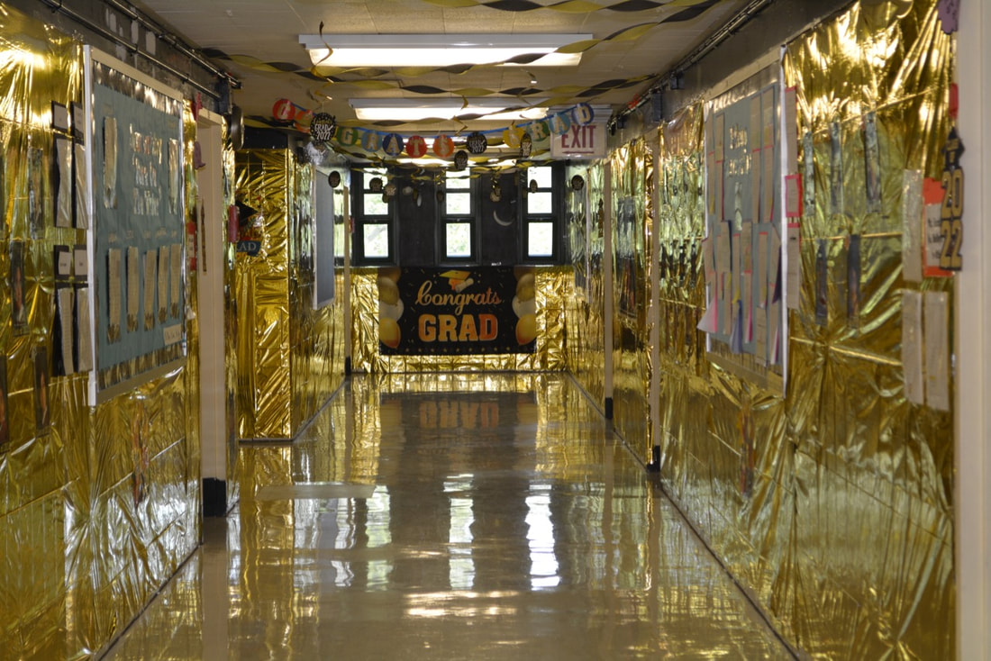Hallway decorated in gold for 2022 graduates.